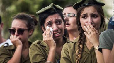 Israeli soldiers weep at the grave of Israeli Sgt. Adar Barsano during his funeral on Sunday, July 20, in Nahariya, Israel.